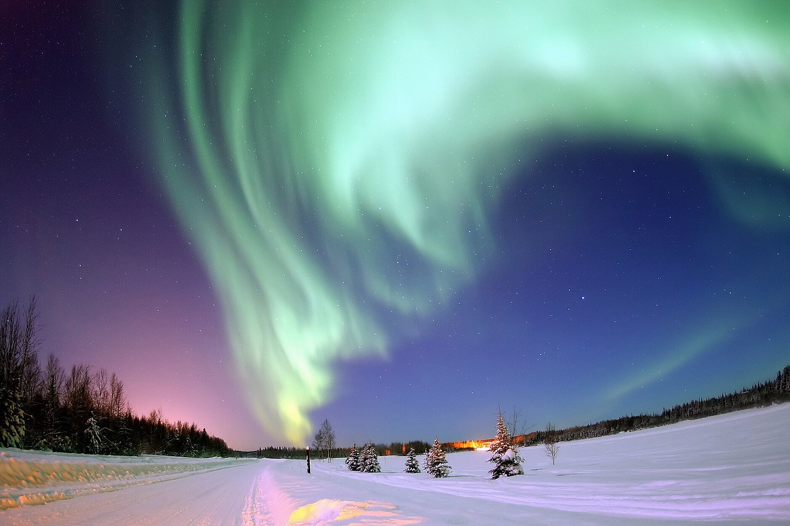 Eielson Air Force Base , Alaska — The Aurora Borealis , or Northern Lights, shines above Bear Lake