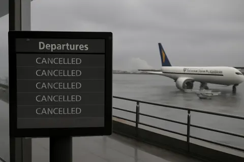 Grounded editorial scene illustrating Singapore Airlines cancels multiple flights as Typhoon Bavi, one of the largest storms in over 30 years, impacts Taiwan, China, and parts of Asia.