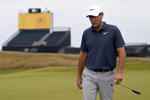 Grounded editorial scene illustrating World number one golfer Scottie Scheffler failed to advance past the cut at the Scottish Open, marking a rare setback ahead of his title defense at the Open Championship.