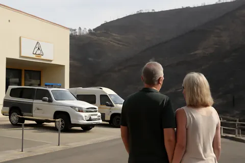Grounded editorial scene illustrating At least 13 people, including five Britons, died in one of Spain's deadliest wildfires, sparking criticism over emergency communication.
