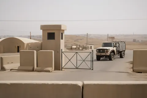 Grounded editorial scene illustrating The two soldiers killed at Muwaffaq Salti Air Base mark the first U.S. military deaths since renewed hostilities with Iran began.