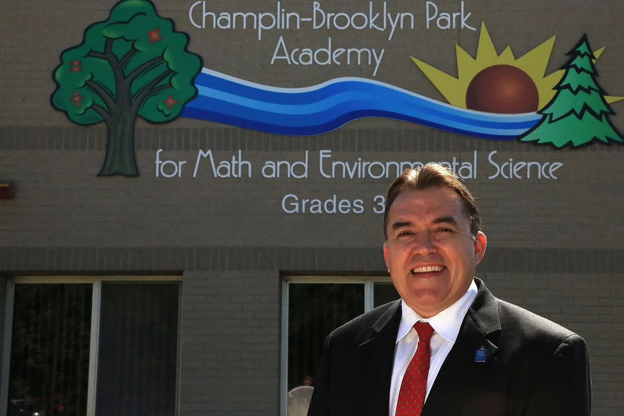 Senator John Hoffman in front of the award winning elementary school he helped create and name as school board member.
