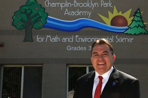 Senator John Hoffman in front of the award winning elementary school he helped create and name as school board member.