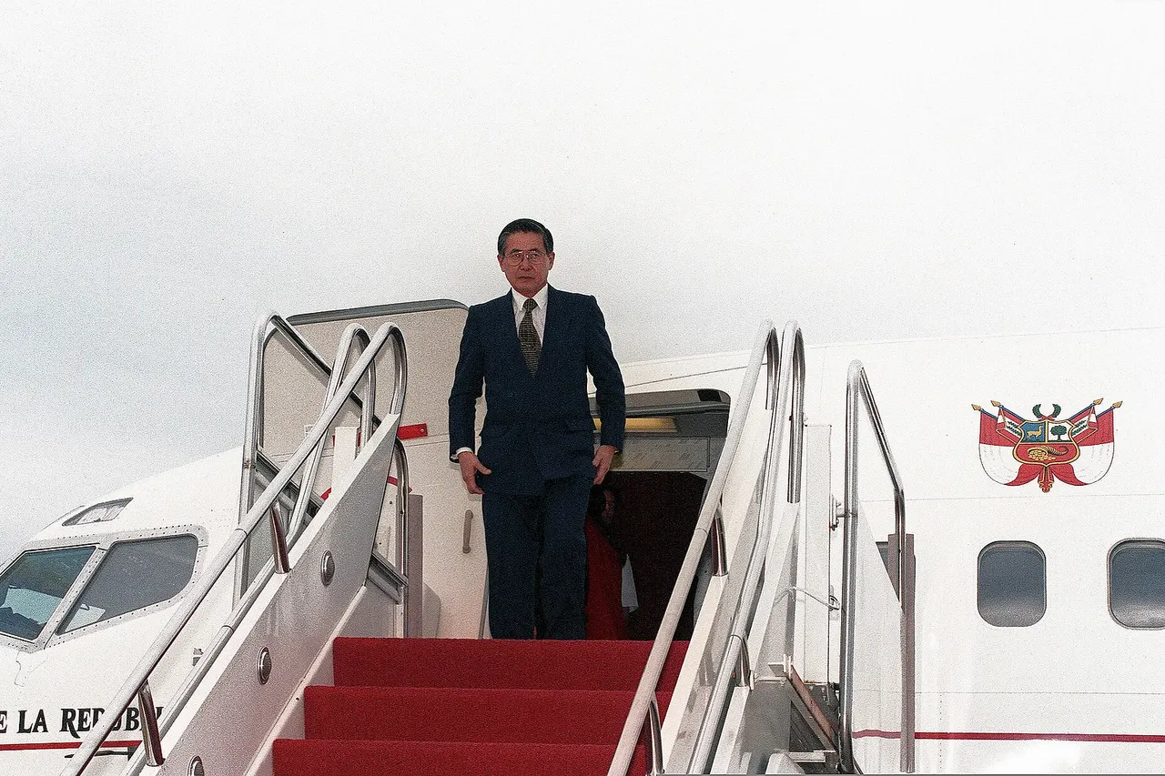 Alberto Fujimori, the President of Peru, emerges from his aircraft moments after arriving in Prince George's County, Maryland, in October 1998.