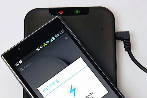 Wireless charging pat for LG smartphone, using the Qi (pronounced 'Chi') international inductive power standard published by the Wireless Power Consortium (WPC). The phone is placed on the pad and it automatically charges.