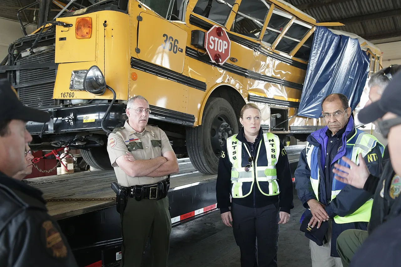 Joe Warren, Chattanooga investigator briefs NTSB Chairman Hart and NTSB Highway Investigator Jennifer Morrison on the damage to the school bus November 22, 2016. NTSB Photo by Nicholas Worrell.