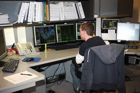A meteorologist at the National Weather Service Operations Center in Flagstaff, analyzes data on an upcoming snow storm. The forecast they generate will give area residents an accurate estimate of when the storm will hit, and how much snow can be expected.