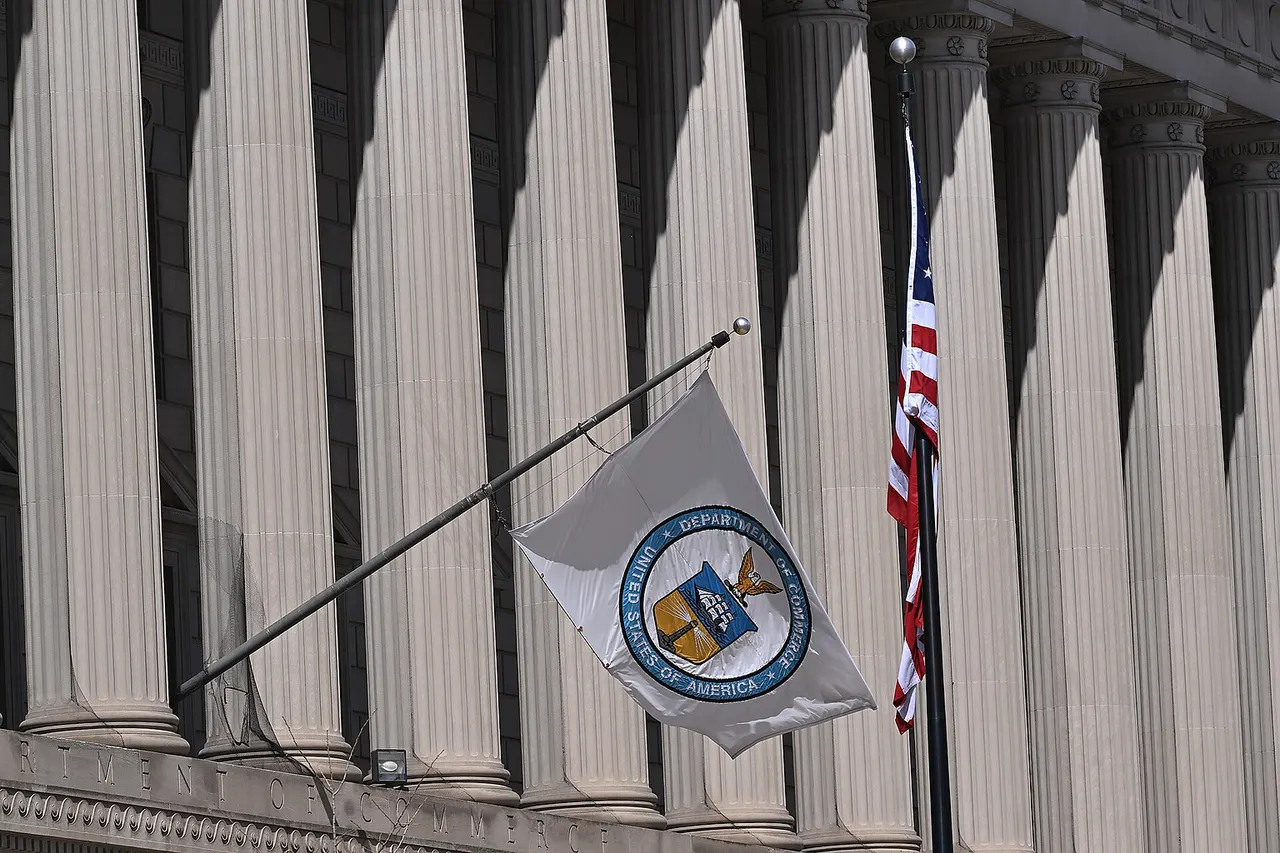 The United States Department of Commerce flag blowing in the wind outside the Herbert C. Hoover headquarters building. 1401 Constitution Avenue NW, Washington, DC 20230.