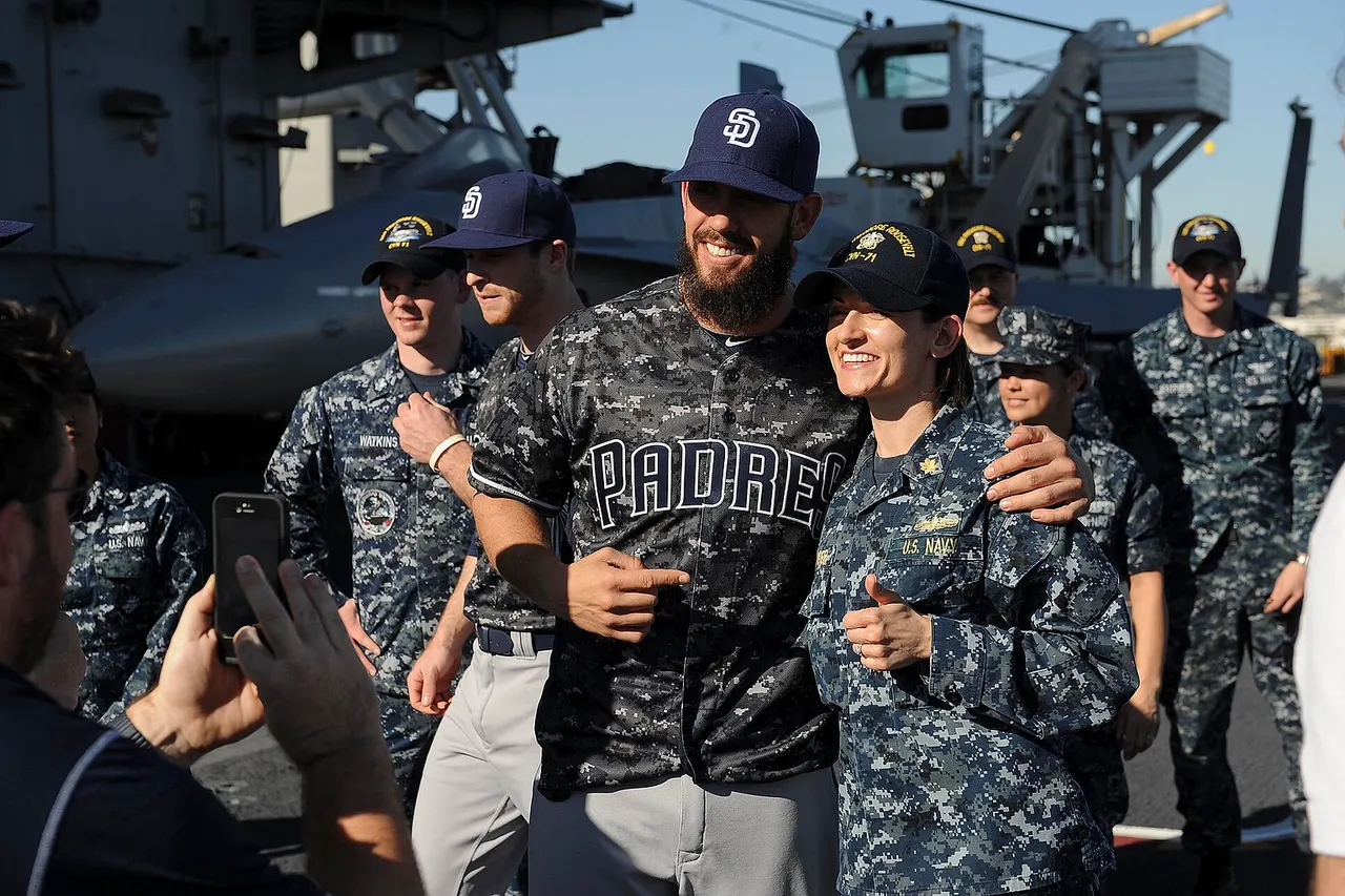 160211-N-ZF498-096 SAN DIEGO (Feb. 11, 2016) – Lt. Cmdr. Lara Bollinger takes a photo with a member of the San Diego Padres Baseball team on the flight deck of the aircraft carrier USS Theodore Roosevelt (CVN 71). Theodore Roosevelt is homeported in San Diego awaiting a regularly-scheduled maintenance period. (U.S. Navy photo by Mass Communication Specialist 3rd Anthony N. Hilkowski/Released)