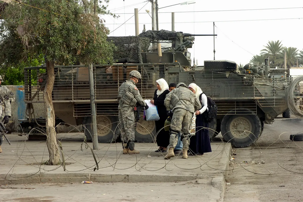 Spc. Shawn Christensen, a native of Smithfield, Utah, and Spc. Ray Villa, a native of Lawrence, Kan., infantrymen with Headquarters and Headquarters Company, 1st Battalion, 23rd Infantry Regiment, 3rd Stryker Brigade Combat Team, 2nd Infantry Division, check the bags of local nations during the Multi-National Division - Baghdad's main clearance effort, operation "Arrowhead Strike 9," in the Iraqi capital's Ghazaliyah neighborhood March 26.