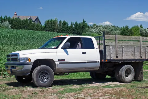 1999 Dodge Ram Cab 2500 Chassis Club Cab 4x4, 5.9 litre Cummins inline-six 24V turbodiesel. Built at Dodge's St. Louis North plant, this agricultural truck has a GVWR of 8,800 lbs. A stake bed truck follows the design of a standard flat bed, but with sockets along the edge that allow upright stakes to be fixed. When the stakes are fixed, they form a fence around the cargo area.