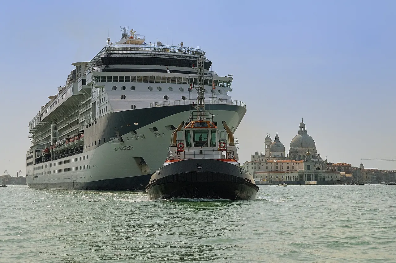 Cruise ship Celebrity Summit towed by the tugboat Vanna C leaving Venice. In the background the basilica Santa Maria della Salute .