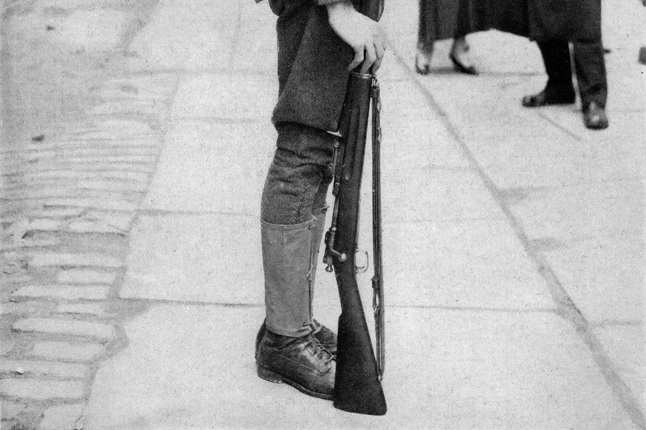 A NATIONAL GUARDSMAN COMPLETELY EQUIPPED FOR SERVICE. On his back this American fighting man carries his blanket roll, small shovel, hat, etc. His canteen is at his belt. He is armed with a .30 caliber U. S. Army rifle. Minimum weight for maximum efficiency is the principle upon which his whole outfit has been designed.