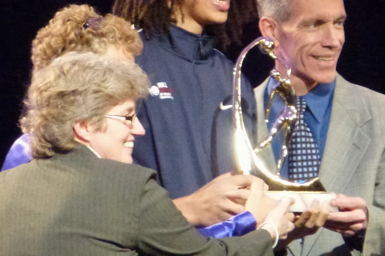 Brittney Griner accepting Wade Trophy at the WBCA Awards show in Denver Colorado. The male is the State Farm Representative.