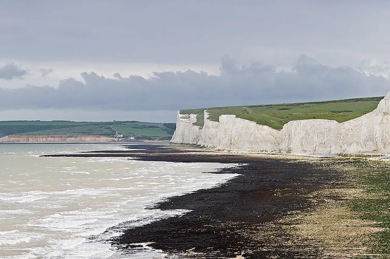 The Seven Sisters , a series of seven chalk cliff peaks along the East Sussex coast in England. Seaford head in the background is on the other side of the River Cuckmere and not part of the Seven Sisters. Taken by myself as a series of 7 frames with a Canon 5D and 70-200mm f/2.8L lens at 200mm.