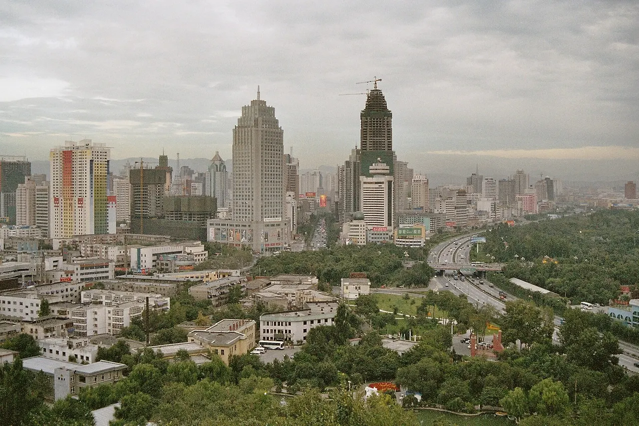 The city of Ürümqi , Xinjiang, China. Taken from a pavilion on the top of a small hill, north of downtown; coordinates 43°48′24.54″ N 87°36′01.17″ E, facing 165°.