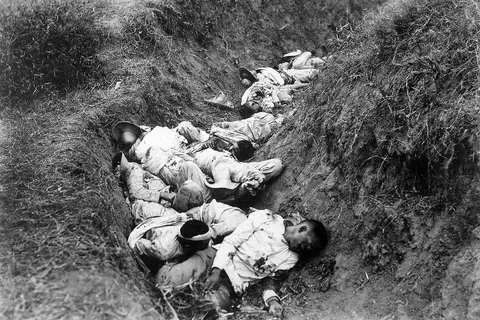 Filipino casualties on the first day of the Philippine-American War . Original caption is 'Insurgent dead just as they fell in the trench near Santa Ana, February 5th. The trench was circular, and the picture shows but a small portion.'