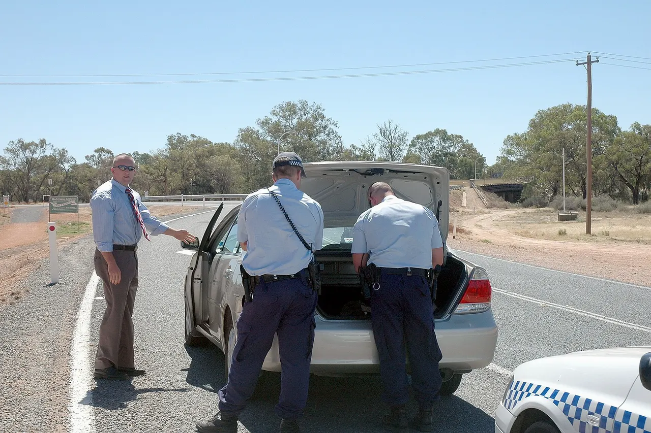 Police (from Dareton, NSW) search the vehicle of a suspected drug smuggler in Wentworth, near the border of New South Wales and Victoria, Australia