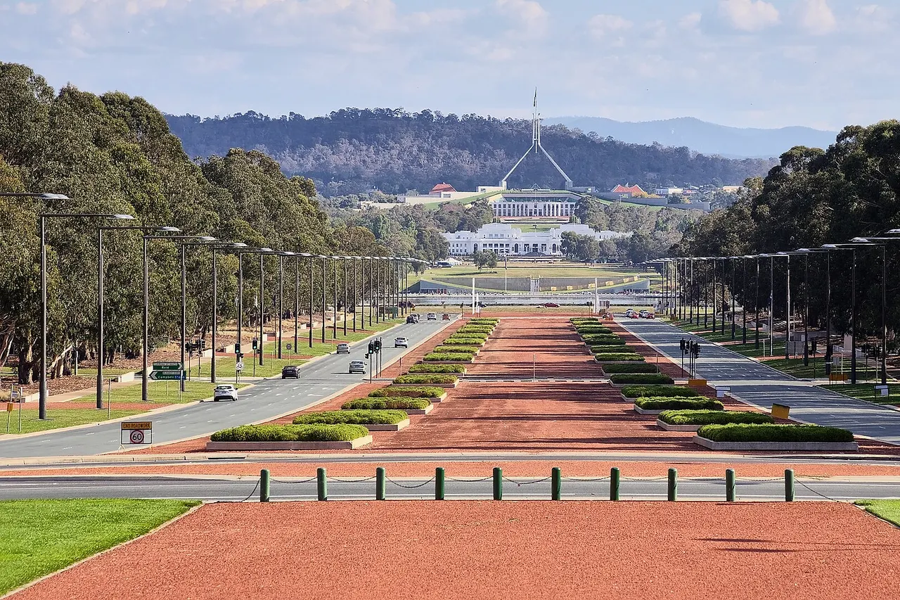 Anzac Parade from the Australian War Memorial in Canberra , ACT . In the distance is Old Parliament House , and behind that is the new Parliament House .