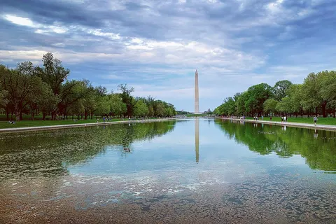 Photo of the Lincoln Memorial Reflecting Pool with The Washington Monument reflecting in the pool on a sunny day