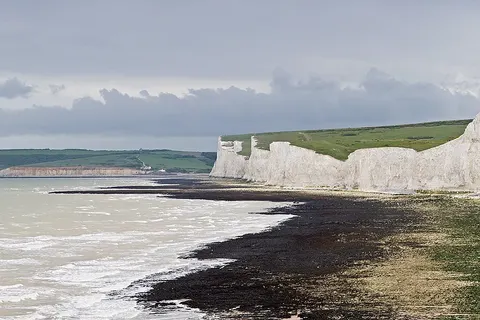 The Seven Sisters , a series of seven chalk cliff peaks along the East Sussex coast in England. Seaford head in the background is on the other side of the River Cuckmere and not part of the Seven Sisters. Taken by myself as a series of 7 frames with a Canon 5D and 70-200mm f/2.8L lens at 200mm.