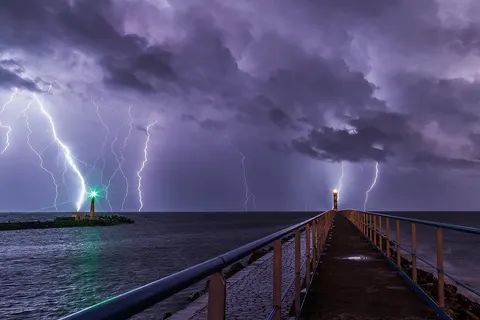 Lightning during an overnight storm at the port and lighthouse in Port-la-Nouvelle in the Aude department in southern France .