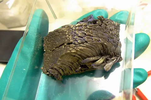 The chemical element Europium , ~300g ingot, crystalline sublimed dendritic, high pure 99.998% Eu/TREM (TREM = Total Rare Earth Metal) . Handled in a glovebox under the inert gas argon .