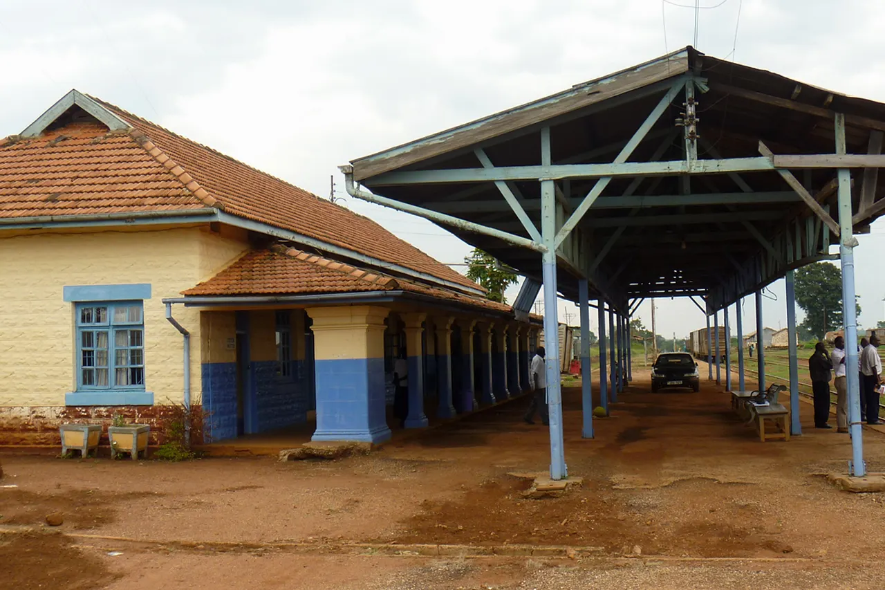 The train station platform, Tororo, Uganda, Sept. 14, 2010. U.S. Army photo by John Hanson Railways, the technology that transformed Europe and America in the 19th century, may yet play a significant role in the future economic development of Uganda. Two U.S. Army logisticians, John Hanson from U.S. Army Africa’s G-4 Programs and Policy Branch, and Lloyd Coakley, from the Military Surface Deployment and Distribution Command’s Transportation Engineering Agency, conducted a four-day assessment of Ugandan railway infrastructure Sept. 13-17 at the request of the Uganda People’s Defense Force’s Engineer Brigade. The mission was to determine the current operational status of the Uganda railway system and its rolling stock, to assess the capability of UPDF personnel to rehabilitate the network, and to identify potential sites for training and repair operations. USARAF and SDDC were invited to contribute their expertise by Brig. Gen. Timothy Sabiiti, commander of the Uganda People’s Defense Force’s Engineer Brigade, Hanson said. “He’s been charged with assisting in the rehabilitation of the railways. It would have a very positive economic impact, including natural resource development. It’s a five-year plan, a complete rehabilitation of the railroad. That’s why they’re doing it. It’s all civil development, but the railroad would be used by the military, too. It would enhance their mobility,” Hanson said. Ugandan assessment team members included Engineer Murungi Daudi, Brig. Gen. George Etyang, Nakaliika Rahmat, Lt. Col. Luke Arikosi, and Engineer Kyamugambi Kasingye. Hanson, Coakley, and their Ugandan hosts, accompanied by a representative of the U.S. Embassy in Kampala, assessed the railroad stations and infrastructure in Jinja, Tororo, Mbale, Kumi, Soroti, Lira and Gulu. They also toured the Nalukolongo Railway Repair Facility in Kampala, he said. “It’s a significant percentage of the railroad, the majority of the rail lines. We saw almost the entire rail line that has not been completely abandoned,” Hanson said. The assessment team found the condition of the Ugandan system to vary greatly by region. The railway is still fully functional and operating in the Jinja-Tororo area, Hanson said. Tororo is the easternmost link on the line before it crosses into Kenya, heading for the coast at Mombasa. As the team progressed north, however, damaged rails were common place, and track along the western section, from Gulu to Pakwach, is in general disrepair, a result of the area being for years under control of the Lord’s Resistance Army. “It’s been pretty much abandoned since then,” Hanson said. Nonetheless, the Ugandan-American team could clearly see the potential for future reconstruction. “The Ugandan government and the UPDF are committed to returning their railway system to a fully operational status. SDDC and USARAF can assist in this effort to help build capacity, not only in Uganda, but eventually throughout the region,” Coakley said. “It was great to partner with another Army Service Component Command on the continent,” said Hanson. “The engineers from SDDC have a lot of experience and expertise that can assist USARAF in finding solutions to the transportation and mobility issues we face throughout most of Africa.” The railroads came to East Africa just before the turn of the 20th century, in the hey-day of European colonial expansion, and England and Germany in particular were in competition to build systems to extract the natural resources of what are today Kenya and Uganda. Beginning in the 1890s, both countries undertook mammoth engineering projects to build railroads from the Indian Ocean coast to Lake Victoria in the interior. The development had profound economic and demographic impacts on the entire region. The influx of workers from British India to build the railways resulted in thriving Indian diaspora communities in both present day Uganda and Kenya; the growth of rail construction centers and nodes stimulated the establishment of such urban centers as Kisumu (then called Port Florence) and Nairobi, both in Kenya. The Ugandan rail line finally reached Kampala in 1931. The northern branch, beginning in Tororo, was extended to Soroti by 1929 and reached Pakwach only in 1964. The presently serviceable rolling stock consists of approximately 1,000 wagons and 35 diesel hydraulic locomotives, said Hanson, and though activity has been dormant in some areas for decades, and clearly in need of rehabilitation, the Ugandan system holds great promise for the future. “SDDC has produced numerous studies on African seaports and infrastructure in the past. USARAF needs to synchronize our efforts with SDDC as they identify future locations to conduct their analyses,” Hanson said. To learn more about U.S. Army Africa visit our official website at <a href=" http://www.usaraf.army.mil " rel="nofollow">www.usaraf.army.mil</a> Official Twitter Feed: <a href=" https://twitter.com/usarmyafrica " rel="nofollow">www.twitter.com/usarmyafrica</a> Official YouTube video channel: <a href=" https://www.youtube.com/usarmyafrica " rel="nofollow">www.youtube.com/usarmyafrica</a>
