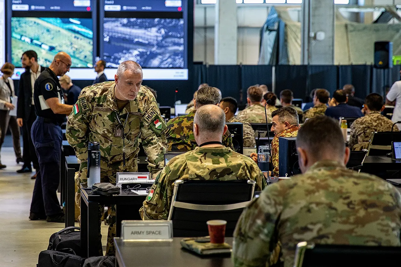 Soldiers assigned to U.S. Army Central, multinational armed forces, and representatives of Non-Government Organizations (NGO) discuss humanitarian aid operations inside the Civil-Military Coordination Center (CMCC) on Dec. 2, 2025, in Israel. The U.S.-led CMCC has grown to include representatives from 50 partner nations and international organizations. (U.S. Army photo by Sgt. Kathryn Skonning)