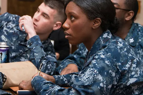 Hospital Corpsman 2nd Class Maya L. Dover and her team carefully consider the answer options to a final round question during an African-American Quiz Bowl during a Black History Month celebration at the Captain James A. Lovell Federal Health Care Center. Teams answered trivia questions based on black history, pop culture and black history within the U.S. Navy. (U.S. Navy photo by Mass Communication Specialist 2nd Class Darren M. Moore/Released)