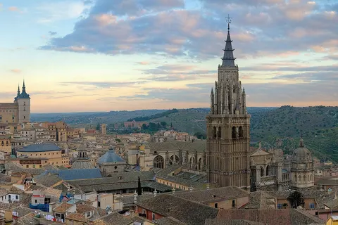 A 4 x 1 segment panorama of the Toledo Skyline in Spain at sunrise. Taken by myself in portrait format with a Canon 5D and 70-200mm f/2.8L lens. On the left Alcázar of Toledo and on the right Cathedral of Toledo .