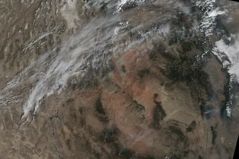 This Moderate Resolution Imaging Spectroradiometer (MODIS) image from August 27, 2002, shows two lightning-caused fires in Arizona. The northernmost is the Trick Fire, which is 17 miles southeast of Williams, AZ. Burning in steep, difficult terrain within the Sycamore Canyon Wilderness Area, the fire was 5,470 acres as of August 29. Trace amounts of rain on the eastern perimeter brought little assistance to the firefighters, who have the fire about 50 percent contained. Due to drought conditions in the area, water is being delivered by rail car to Williams, AZ, from Grand Canyon National Park at a rate of over 60,000 gallons per day. To the south are the Pack Rat Complex, about 15 miles north of Payson, Ariz. Started by lightning, this complex was 2,500 acres by August 29. Image by Jesse Allen, based on data from the MODIS Rapid Response Team at NASA-GSFC