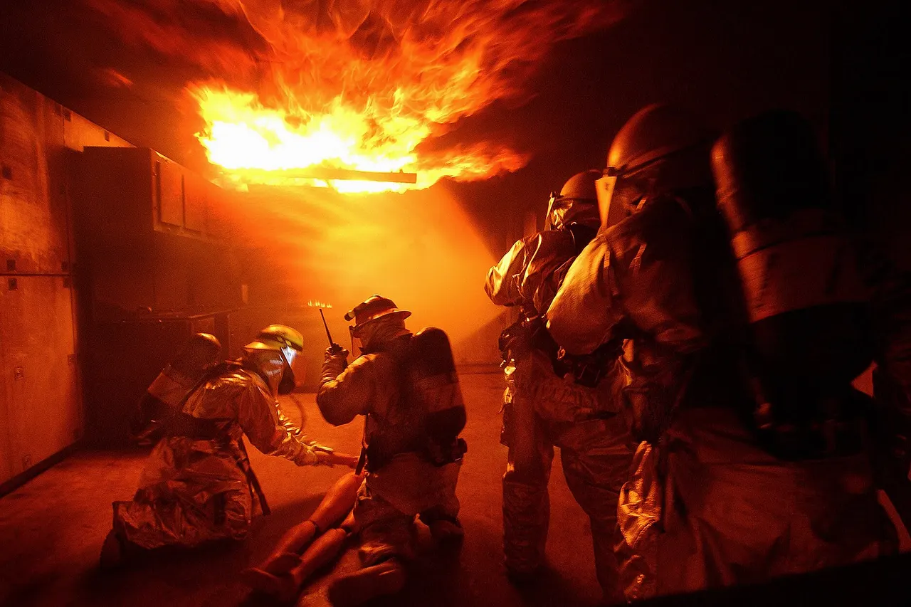When you're hot, you're hot! Airmen from the 18th Civil Engineer Squadron Fire Department conduct training at the Silver Flag area of Kadena Air Base, Japan, Dec. 2 during Beverly High 09-01, a local operational readiness exercise to test the readiness of Kadena's 18th Wing Airmen. (U.S. Air Force photo/Tech. Sgt. Rey Ramon)
