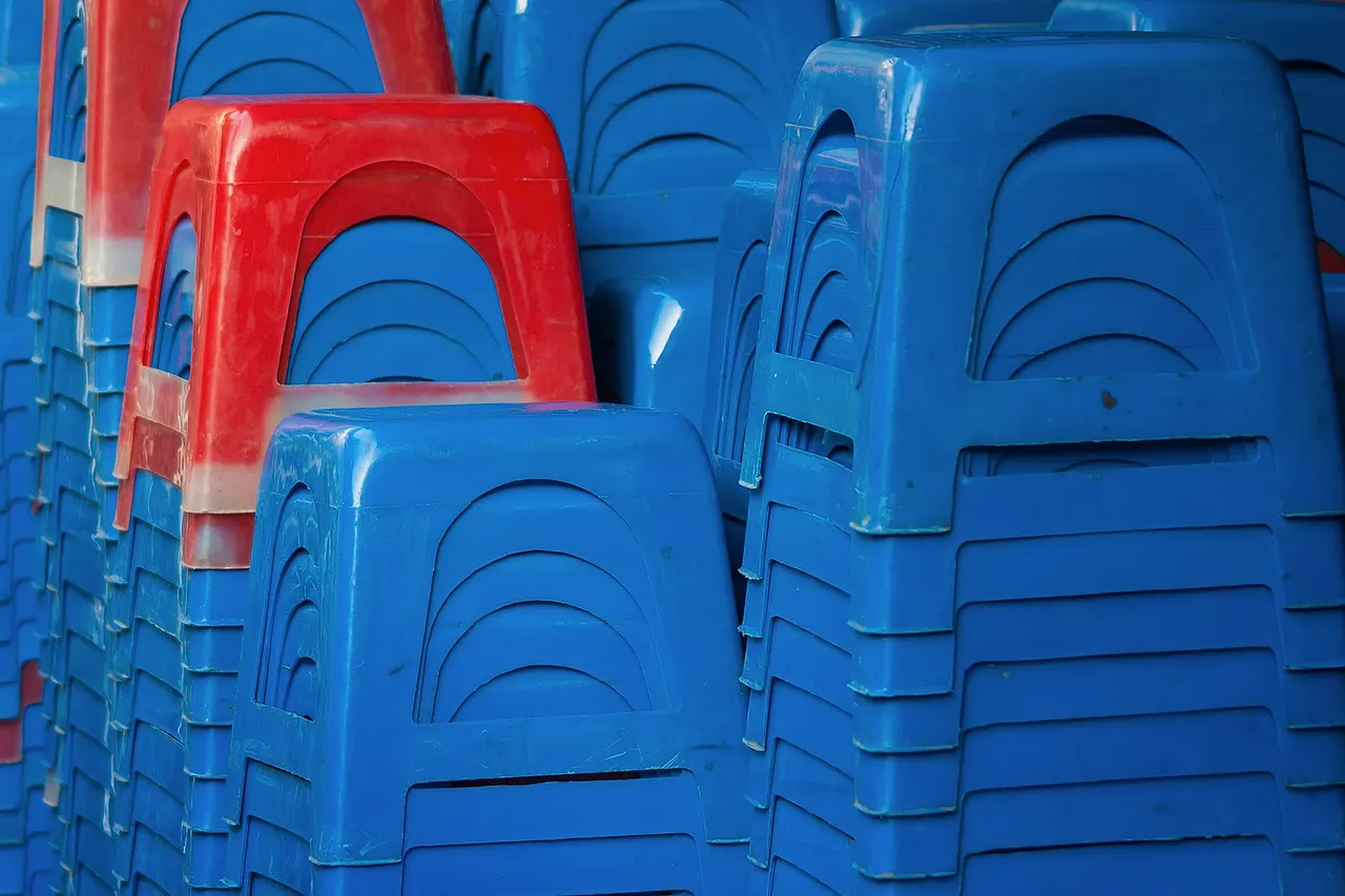 Hanoi, Vietnam: Asia's omnipresent style of plastic stools, stacked in front of a restaurant.