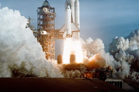 The April 12 launch at Pad 39A of STS-1 , just seconds past 7 a.m., carries astronauts John Young and Robert Crippen into an Earth orbital mission scheduled to last for 54 hours, ending with unpowered landing at Edwards Air Force Base in California.
