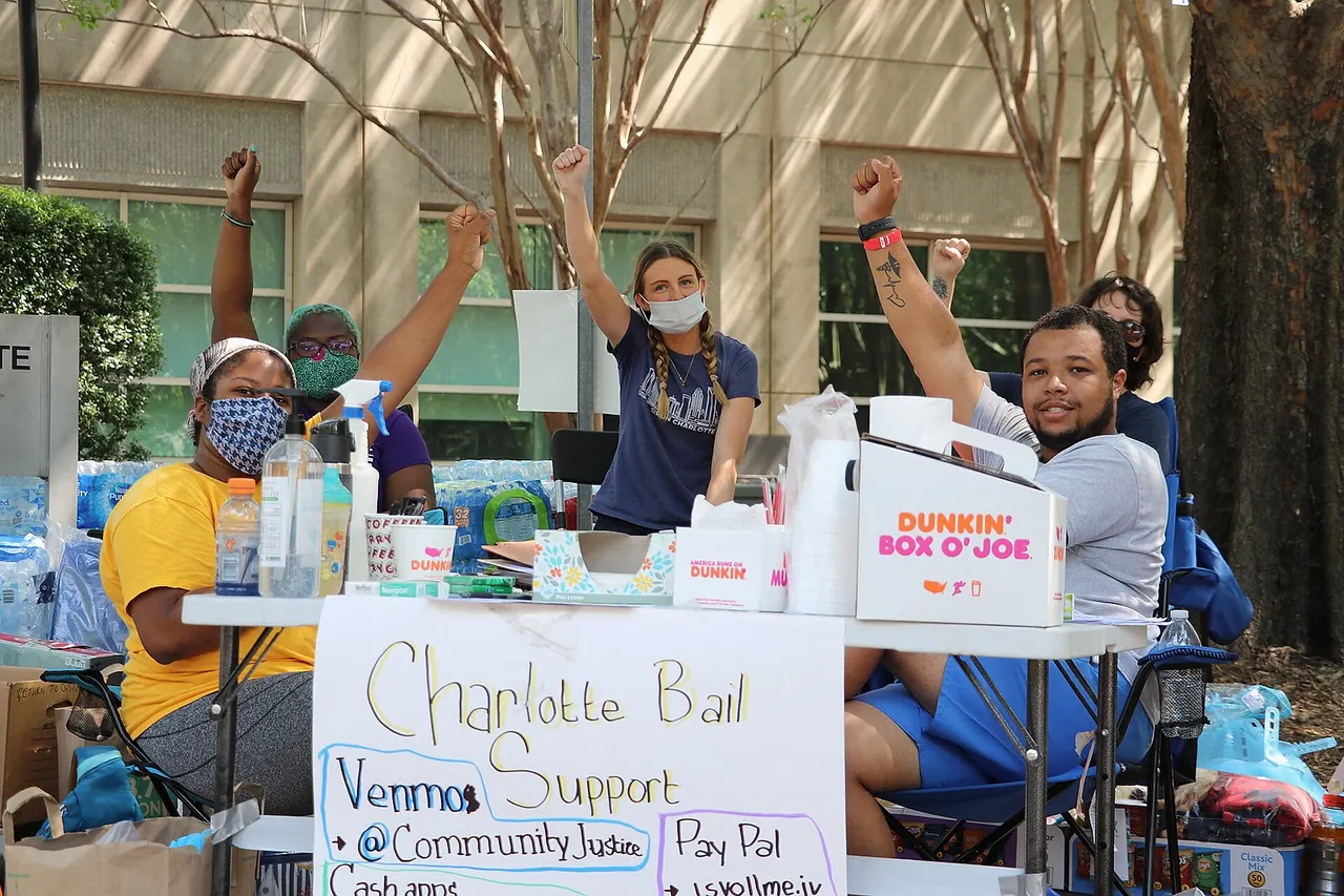 Two protestors at a protest station at the Mecklenburg County Jail during the George Floyd protests.