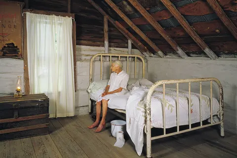 Kate Carter, on her 90th birthday, poses for photographer Carol M. Highsmith in the log cabins in North Carolina, United States, where Highsmith's great-grandfather and grandfather, Pleasant Jiles Carter (1847-1931) and Yancey Ligon Carter (1873-1947), were born and lived in Wentworth, North Carolina.