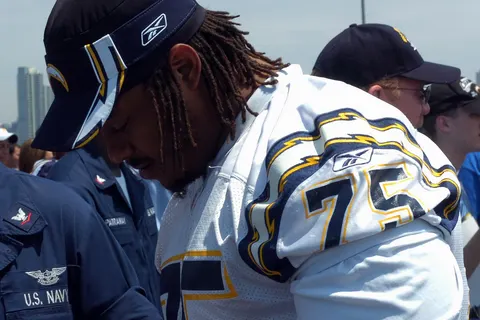 Offensive Tackle for the National Football League San Diego Chargers Leander Jordan (75) signs an autograph for Aviation Electrician's Mate 3rd Class Jerimy Holt during a visit aboard USS Ronald Reagan (CVN 76) in San Diego, Calif., Aug. 11, 2006. The Chargers held practice on the flight deck of the Navy's newest nuclear-powered aircraft carrier in preparation for their first pre-season game against the Green Bay Packers. (U.S. Navy photo by Mass Communication Specialist 3rd Class Christopher D. Blachly) (Released)
