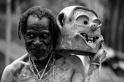 A mudman from Asaro with his unique clay mask . Photo taken at Kabiufa (~5km from Asaro), Eastern Highlands, Papua New Guinea.