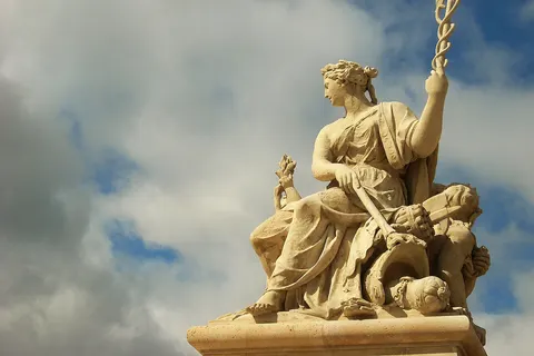 Allegorical sculpture at the entrance to the Palace of Versailles