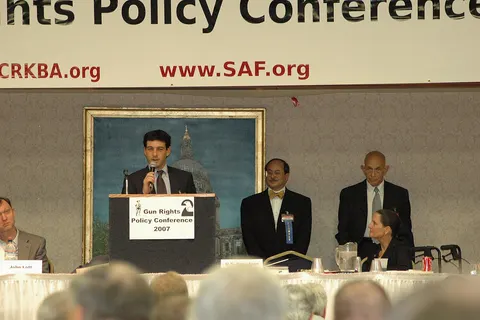 Attorney Alan Gura speaks to gun rights activists on preparations for Parker v. D.C. at the Supreme Court of the United States, while (left to right) John Lott, Alan Gottlieb, Bob Levy, and Congresswoman Jean Schmidt (seated) look on.