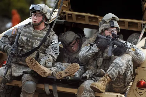 U.S. Army Spc. Nathean Hommer and Sgt. Willard Garmoe provide security from the tailgate of a Humvee as they extract a simulated casualty during a military operations on urban terrain exercise as part of mobilization training at Fort Dix, N.J., on Jan. 10, 2008. Soldiers from the 186th Military Police Company, Iowa Army National Guard, are receiving training from the 72nd Field Artillery Brigade for their upcoming deployment. DoD photo by Staff Sgt. Russell Lee Klika, U.S. Army. (Released) 080110-A-0559K-208.jpg