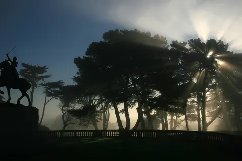 Joan of Arc on horseback, triumphantly raising her sword to the heavens and crepuscular rays at San Francisco's Palace of the Legion of Honor