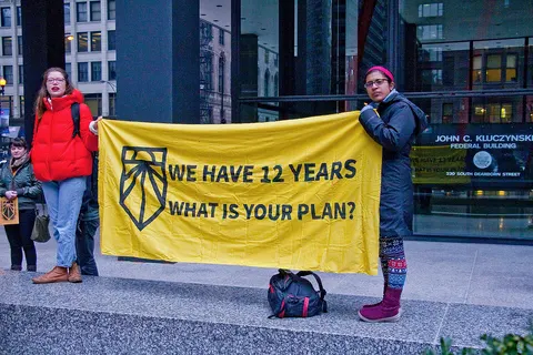 Banner "We have 12 years left, what is you plan?". Chicago Sunrise Movement rallies for a Green New Deal, in Chicago (Illinois), 27 February 2019.