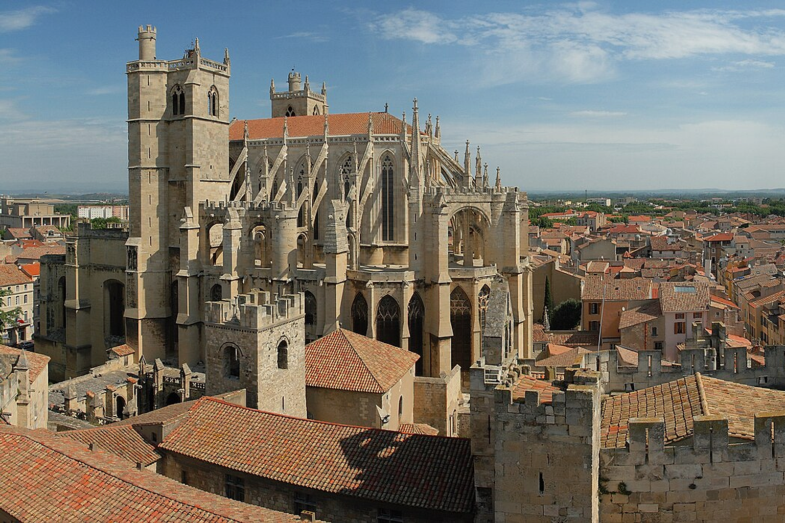 City of Narbonne in south of France, and the Saint Just cathedral, viewed from the Gilles Aycelin dungeon. This panorama is made from 4 portrait pictures taken à 17mm on a 1.6 crop body (28mm équiv.), f/8.0, 1/500s and ISO100. Original pictures were underexposed, but fixed with Gimp. Stitching was done with Hugin and Enblend. Resulting horizontal FOV is about 130°.