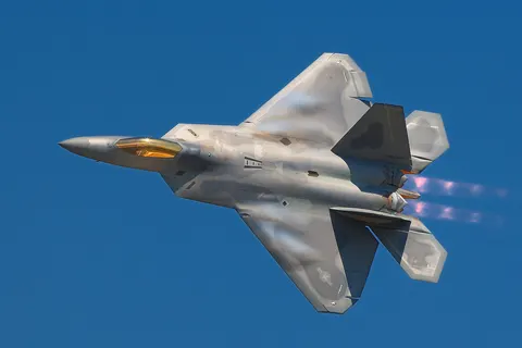A Lockheed Martin F-22A Raptor fighter streaks by at the 2008 Joint Services Open House (JSOH) airshow at Andrews AFB. Despite many great performances most of those at the show wanted to see the latest USAF fighter. The F-22 did not disappoint! See the vapor trails forming on the wings of this F-22. I also found the pulsed look of the F-22's engines to be a really interesting visual effect.