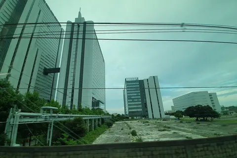 Vacant land surrounded by NEC buildings