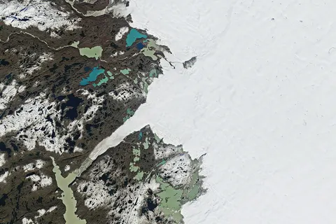 Ice covers about 1.7 million square kilometers (656,000 square miles) of Greenland, forming the largest ice sheet on Earth outside of Antarctica. Each summer, its surface begins to melt under the warmth of the Sun, intensified by the season’s long daylight hours and sometimes further enhanced by clouds and rain. Greenland’s melting season usually runs from May to early September. The 2025 season was considered “moderately intense,” ranking 19th in the 47-year satellite record for cumulative daily melt area as of late August, according to an analysis by the National Snow and Ice Data Center (NSIDC). This year’s season featured an extended period of melting in part of July and a sharp increase in warmth and melting in mid-August. The mid-August spike, which was preceded by significant rainfall in some areas, peaked on August 21, when melting was observed across nearly 35 percent of the ice sheet—a record for that date, according to the NSIDC. These satellite images show the ice sheet on that day (left) and nearly two weeks later (right), along part of its southwestern edge about 150 kilometers (90 miles) northeast of the capital city of Nuuk (not shown). Both images were captured by the OLI-2 (Operational Land Imager-2) on Landsat 9. In the August image, a vast expanse of gray, “dirty” ice is visible. The darker appearance is due to particles like black carbon and dust that have accumulated on the ice sheet. As the snow and ice melt, these impurities are left behind, making the ice appear even darker. This darkening reduces the ice’s albedo—its ability to reflect sunlight—causing it to absorb more solar energy and melt even faster during the summer months. Several ponds of light- and deep-blue meltwater dot the ice, and scattered clouds cover part of the ice sheet in the middle and bottom-right of the scene. By the date of the September image, a fresh layer of snow appears to cover much of the dirty ice as well as some of the land. While major melt events have occurred as late as September in previous years, they become less likely this time of year as temperatures typically drop with the Arctic’s diminishing daylight. Scientists track seasonal melting each year because it is one of the ways the massive Greenland Ice Sheet loses ice. (Iceberg calving and melting at the base of tidewater glaciers also play a role.) As air and water temperatures have risen in recent decades, ice losses have outpaced ice gains, contributing to sea level rise. NASA Earth Observatory images by Wanmei Liang, using Landsat data from the U.S. Geological Survey. Story by Kathryn Hansen.