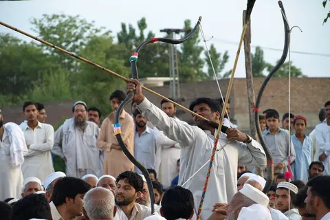 Makha or Mukha (local archery game) – a man stretching a bow at village Kotha in district Swabi, KPK, Pakistan.