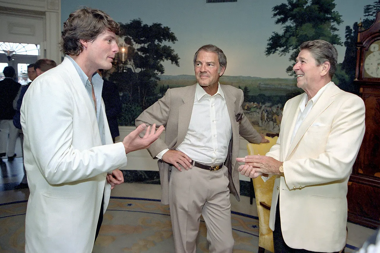 President Reagan talking with Christopher Reeve and Frank Gifford during a reception and picnic in honor of the 15th Anniversary of the Special Olympics program in the Diplomatic Reception room.
